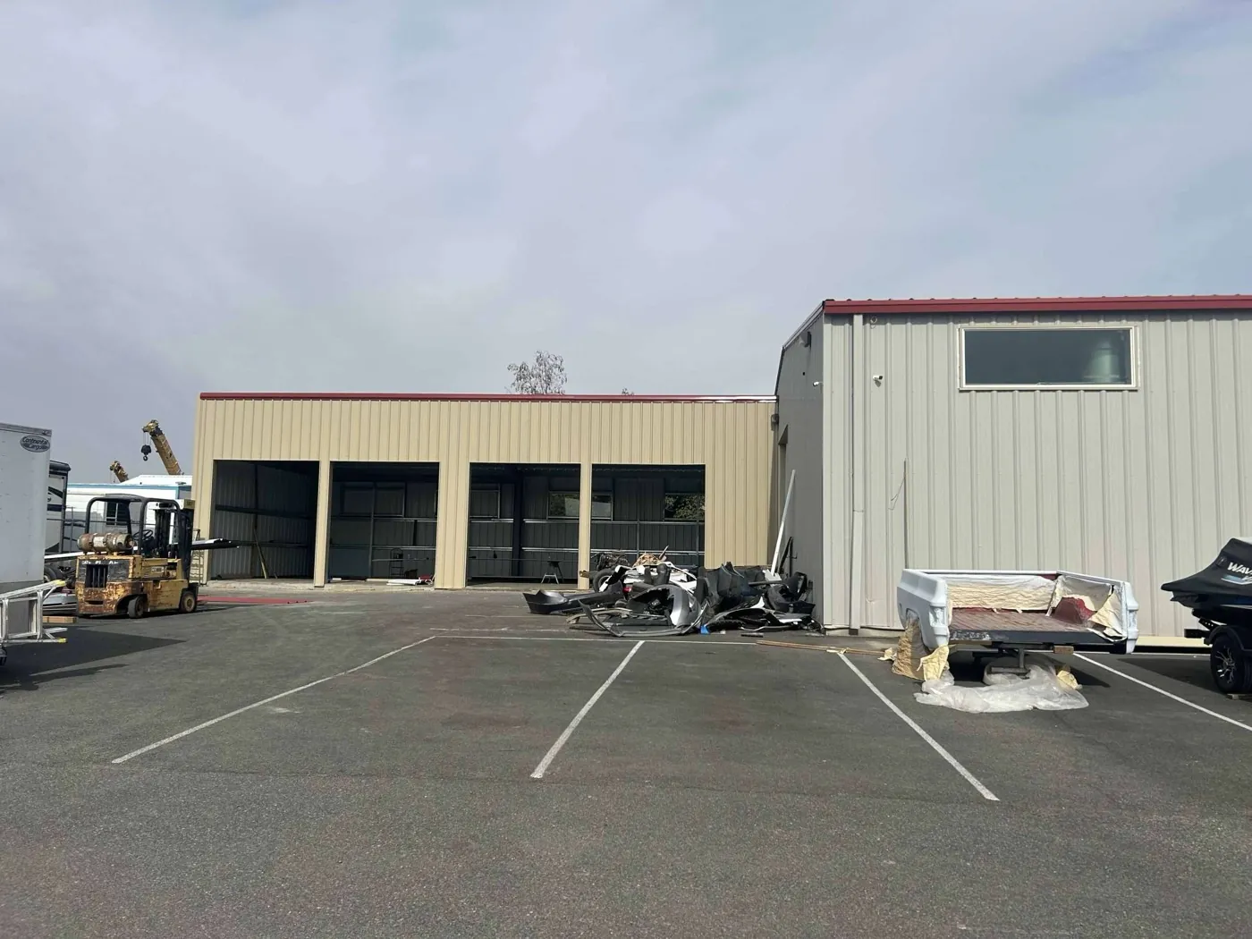 Commercial building with an installed window and red metal roof trim